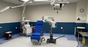 A bright blue chair sits in the center of a bright and clean operating room for eye surgery at Specialized Surgical Center of Central New Jersey (SSC)