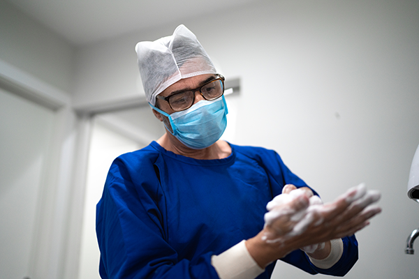 An eye surgeon for Specialized Surgical Center of Central New Jersey cleans his hands thoroughly before surgery